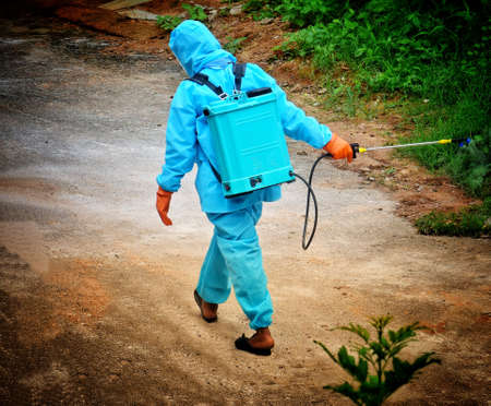 sanitation worker wearing suit and spraying alcohol based solution due to the corona virus,Covid-19 in the hyderabad cityの写真素材