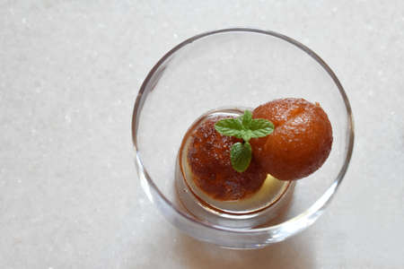 Indian Sweet food called Gulab Jamun made up of milk and sugar, a popular dish in festival or special occasion. Selective focusの写真素材
