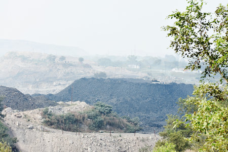 Coal dump on the outskirts of the city in the fog.