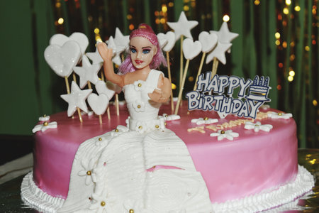 Birthday cake with the image of a girl with pink hair.の写真素材