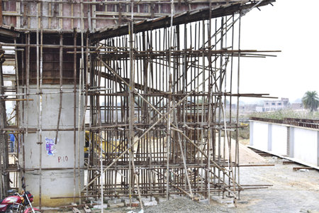 Construction site with scaffolding and building materials. Building under construction.
