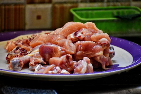 Raw meat on a plate in the kitchen. Selective focus.の写真素材