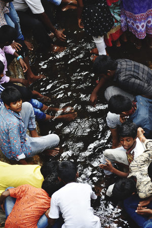 People washing their hands in the river, Kolkata, West Bengal, India