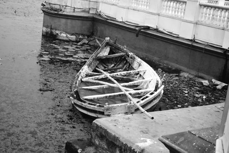 Old boat on the bank of the river. Black and white photo.の写真素材