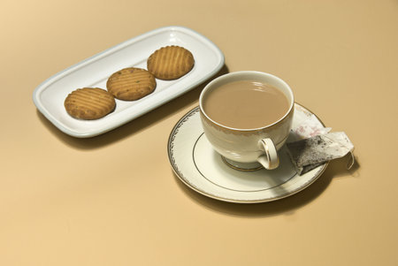Cup of tea, tea bag and cookiesの写真素材