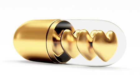 Golden hearts in the medical capsule isolated on white backgroundの写真素材