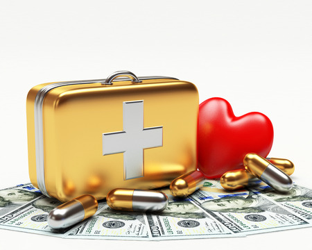 Golden first aid kit, red heart and pills on dollar bills isolated on white backgroundの写真素材