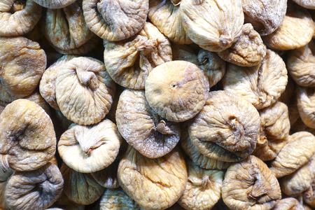 A bunch of dried figs as a background. Sale of dried fruits on the market.の写真素材