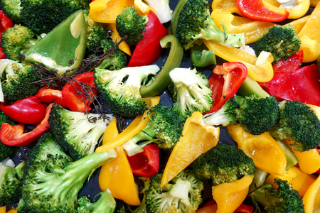 Slices of vegetables as a background. Colorful fresh pepper, cauliflower and broccoli mixed.の写真素材
