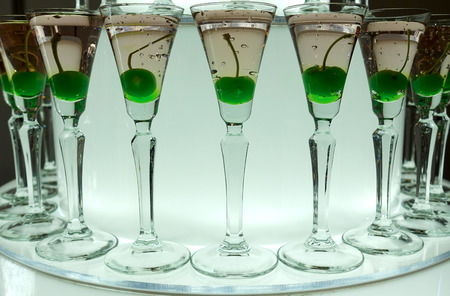 Close-up of glasses with champagne and cocktails on a tray.の写真素材
