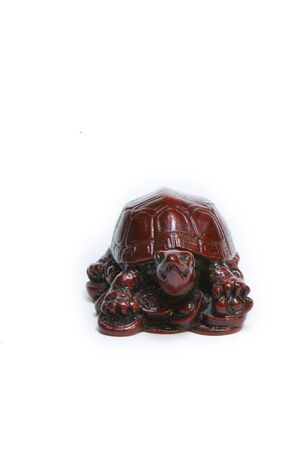 brown statuette of east god from a stone on a white backgroundの写真素材