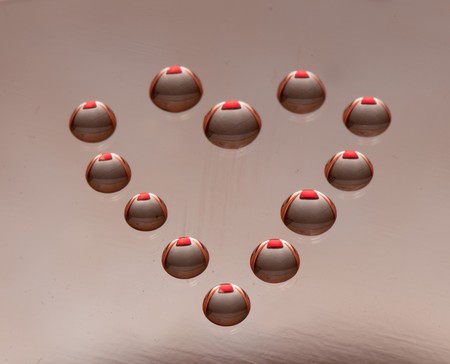 Water drops in the form of heart on a celebratory backgroundの写真素材