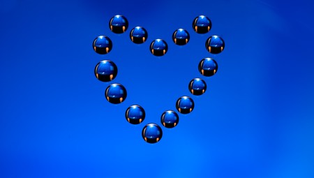Water drops in the form of heart on a celebratory backgroundの写真素材