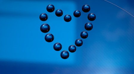 Water drops in the form of heart on a celebratory backgroundの写真素材