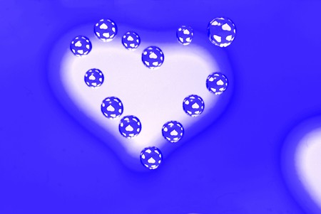 Water drops in the form of heart on a multi-coloured celebratory backgroundの写真素材