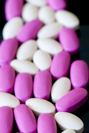colored oblong pills on the isolated background