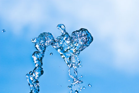 Beautiful splashes of water on a background blue sky
