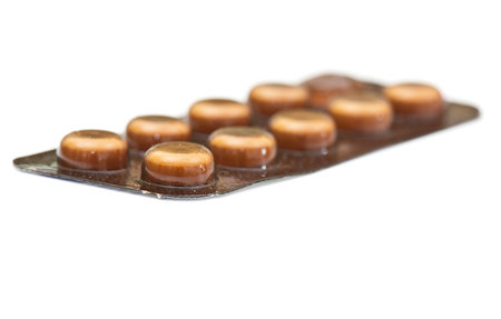 white round pills on the white isolated backgroundの写真素材