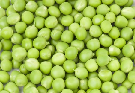 fresh green peas isolated on a white backgroundの写真素材