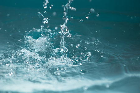 Beautiful splashes of fresh water on a color background
