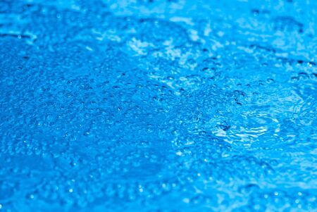 Beautiful splashes of fresh water on a color backgroundの写真素材