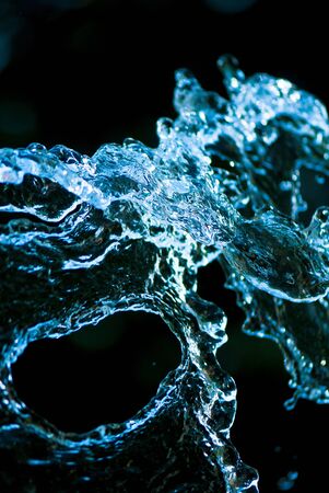 Beautiful splashes of fresh water on a color backgroundの写真素材