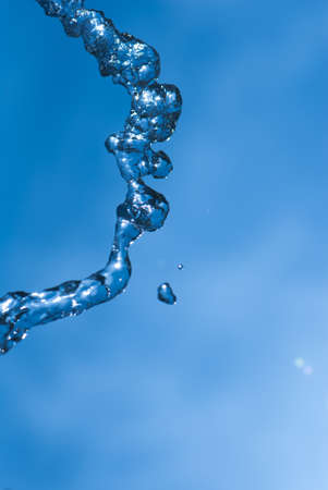 Beautiful splashes of fresh water on a color backgroundの写真素材
