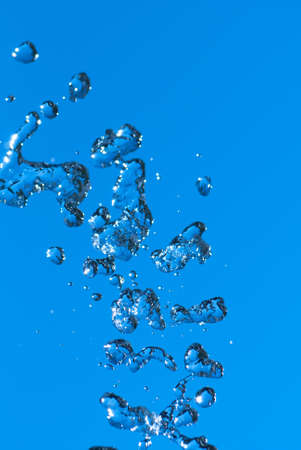 Beautiful splashes of fresh water on a color backgroundの写真素材