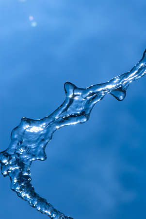 Beautiful splashes of fresh water on a color backgroundの写真素材