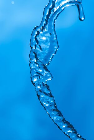 Beautiful splashes of fresh water on a color backgroundの写真素材