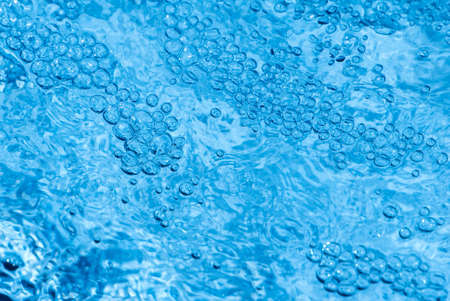 Beautiful splashes of fresh water on a color backgroundの写真素材