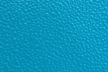 Beautiful splashes of fresh water on a color backgroundの写真素材