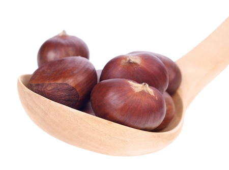 chestnuts in wooden spoon on white background の写真素材