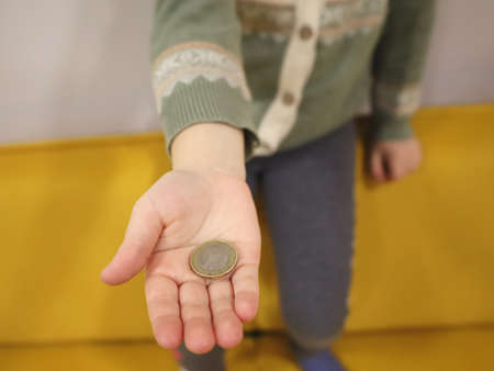 financial literacy for children. girl sitting at a laptop with glasses on a yellow sofa. study, businessの写真素材