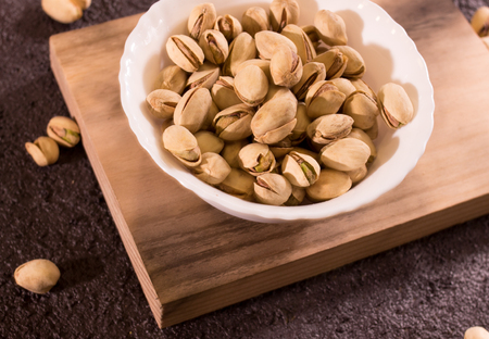 pistachios in wooden boardの写真素材