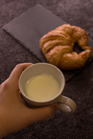 croissant with glass of milk on wooden boardの写真素材