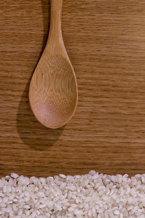 white rice texture on wooden tableの写真素材