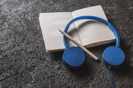 Top view of notebook with blank screen, pencil ,earphonesの写真素材