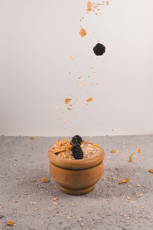 oat flakes and corn with blackberries in bowl