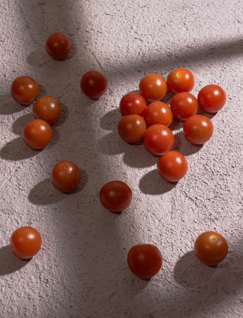 Fresh cherry tomatoes on old wooden tableの写真素材