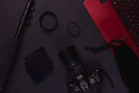 black desktop with photography equipment and laptopの写真素材