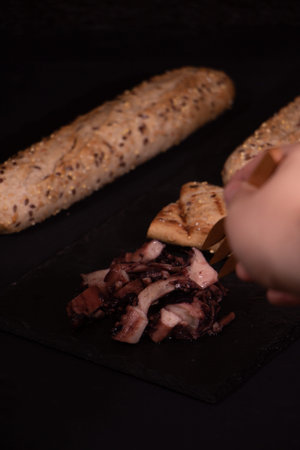 Octopus slice with cereal bread plated