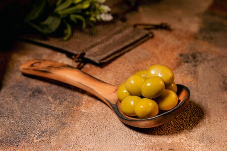 green olives on wooden tableの写真素材