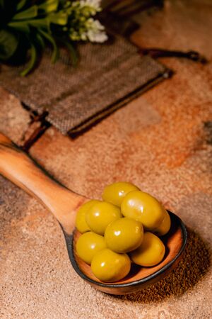 green olives on wooden tableの写真素材