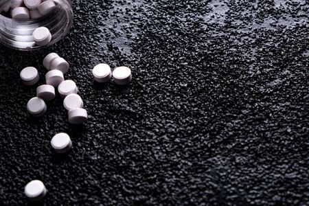 medicine bottle lying on the floor. medicines thrown on the roadの写真素材