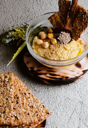 Chickpea hummus with sesame on white wooden board, top view. Vegan foodの写真素材