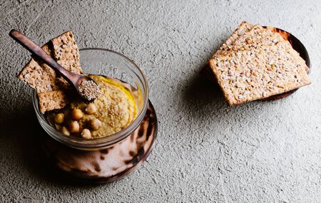 Chickpea hummus with sesame on white wooden board, top view. Vegan foodの写真素材