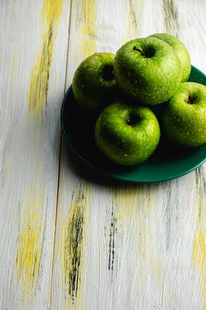 Fresh green apples on old wooden table. Healthy and ecological food. Color harmonyの写真素材