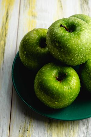 Fresh green apples on old wooden table. Healthy and ecological food. Color harmonyの写真素材