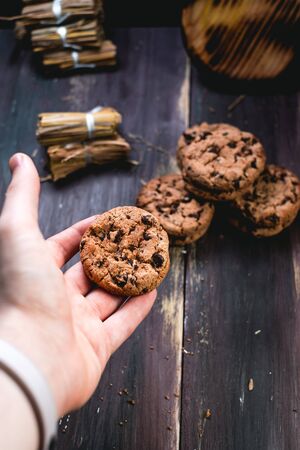 Chocolate cookies on wooden table. Chocolate chip cookies shot on blackの写真素材